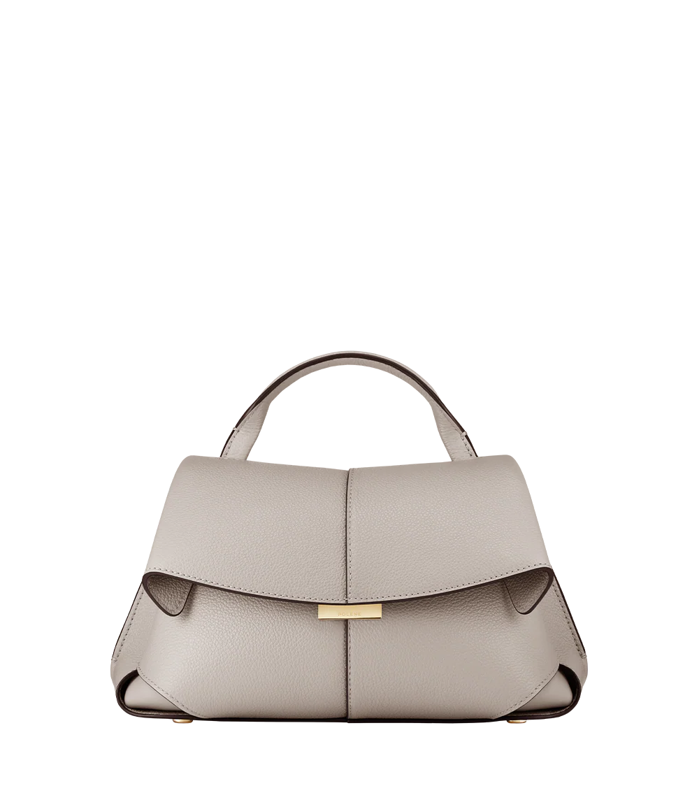 Elegant Taupe Pebbled Leather Top-Handle Crossbody Bag with Fold-Over Flap and Adjustable Strap Styled with Oversized Chunky Knit Sweater
