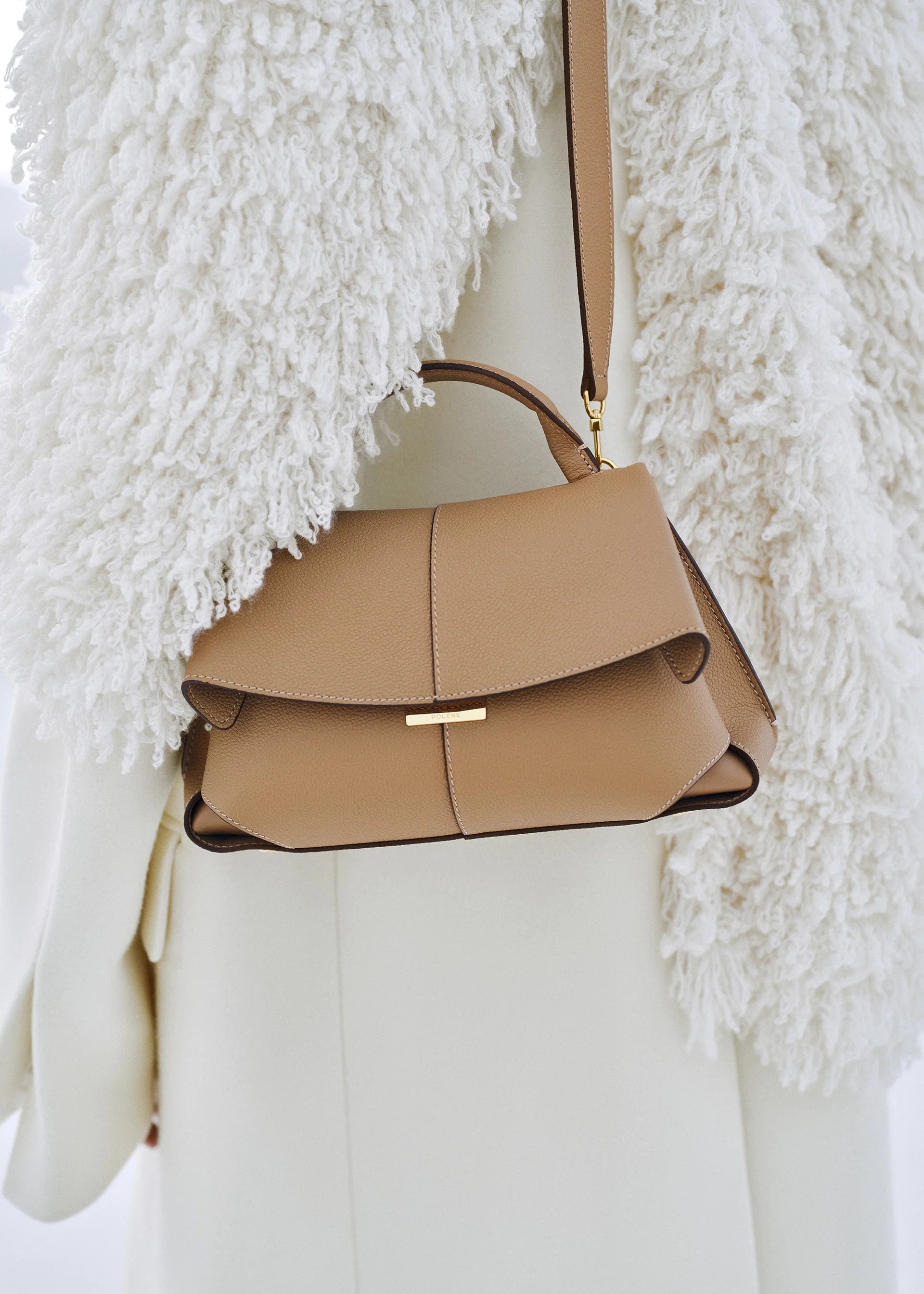 Elegant Camel Pebbled Leather Top-Handle Handbag with Fold-Over Flap, Adjustable Strap, and Gold-Tone Hardware Styled in Luxe Winter Look