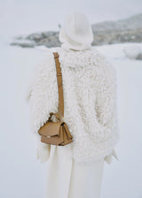 Elegant Camel Pebbled Leather Top-Handle Handbag with Fold-Over Flap, Adjustable Strap, and Gold-Tone Hardware Styled in Luxe Winter Look