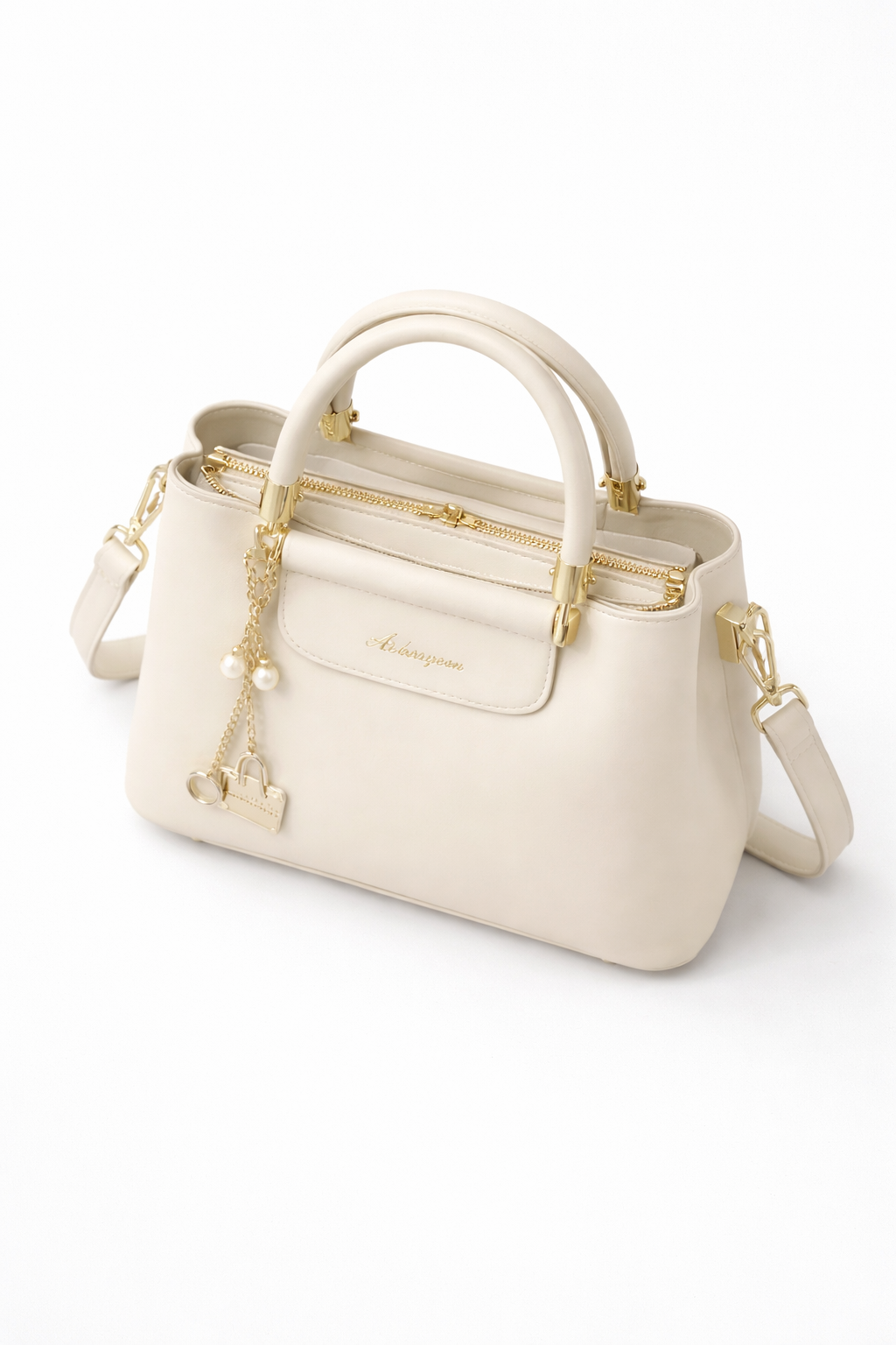 Smooth minimalist front panel enhanced with a structured flap detail and a detachable gold charm chain featuring pearl and mini handbag accents for a refined luxury-inspired finish.